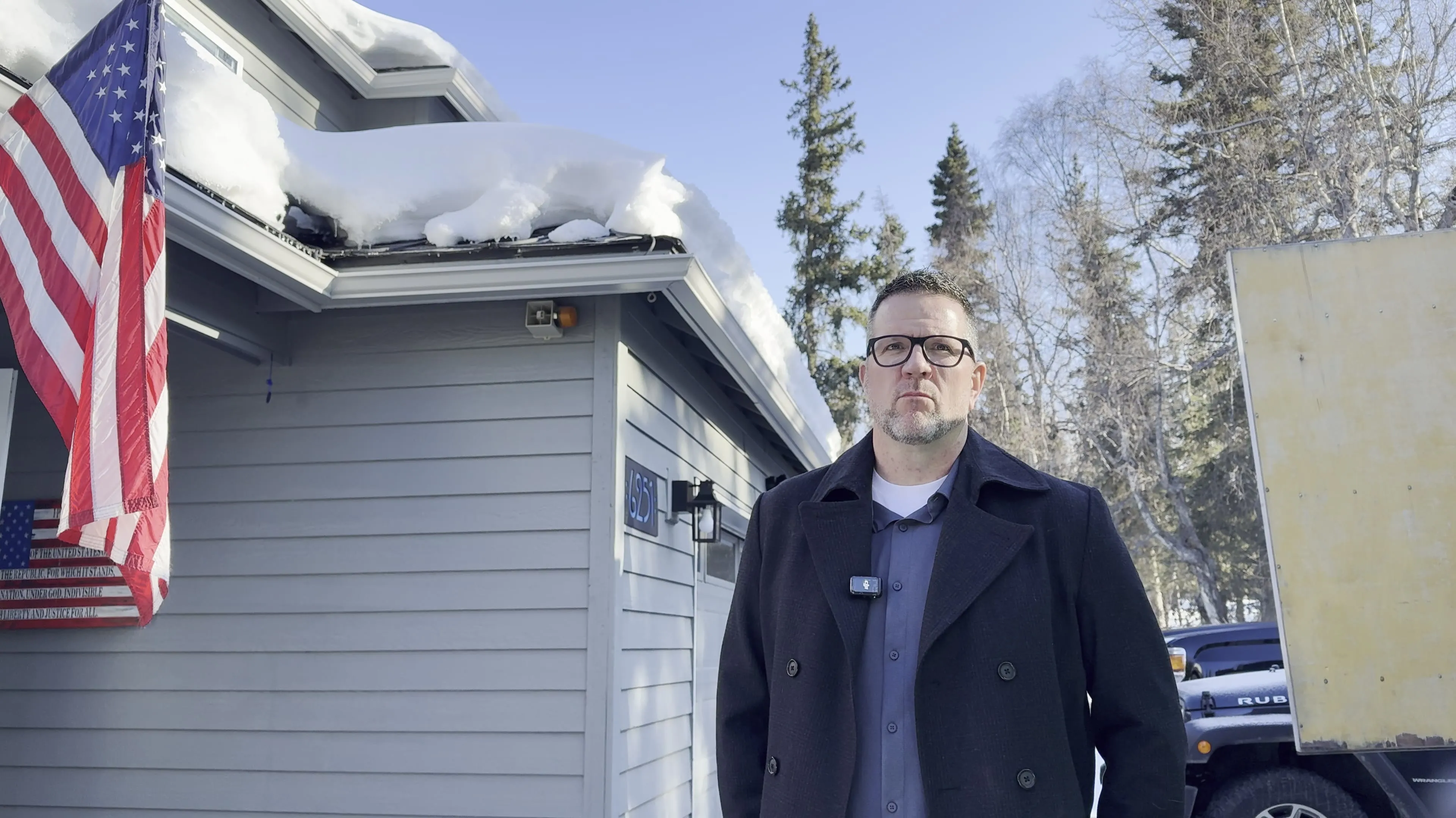 Greg, a repeat Alaska Heat Cable customer, in front of his protected roof